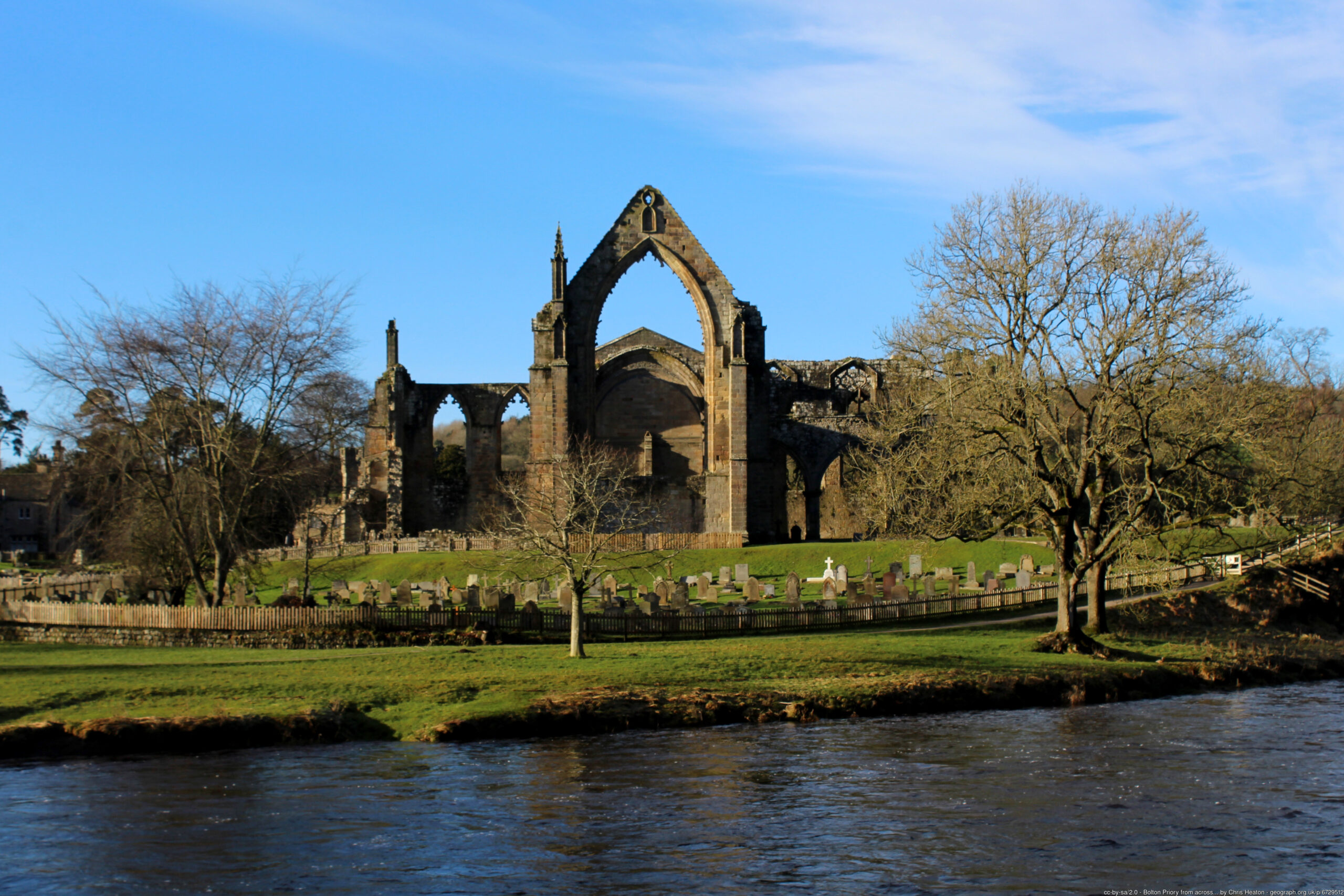 bolton abbey with blue sky in front of water