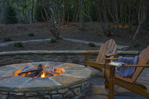 fire pit with wooden chairs