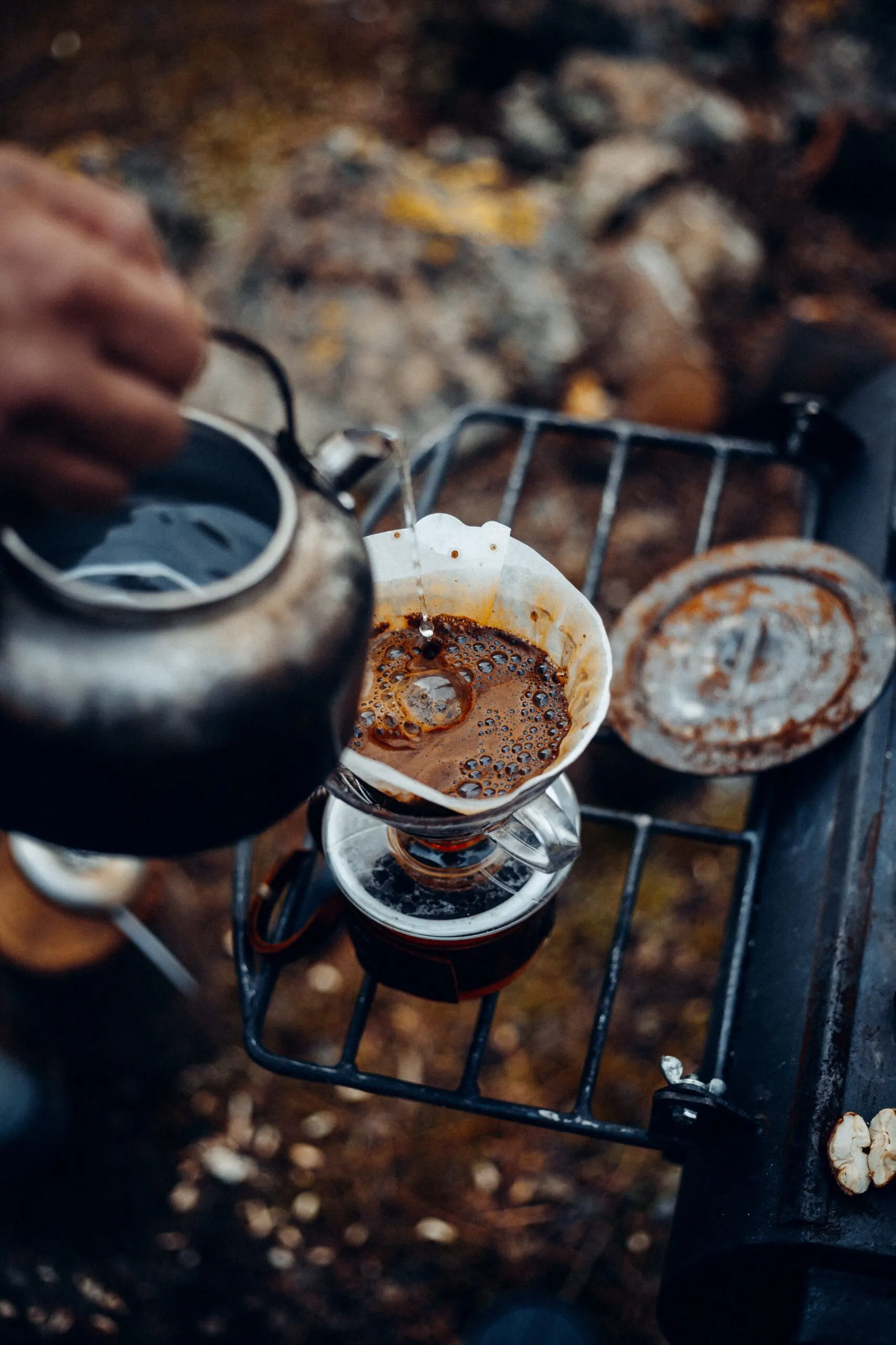 Hand making coffee while resting in mountains