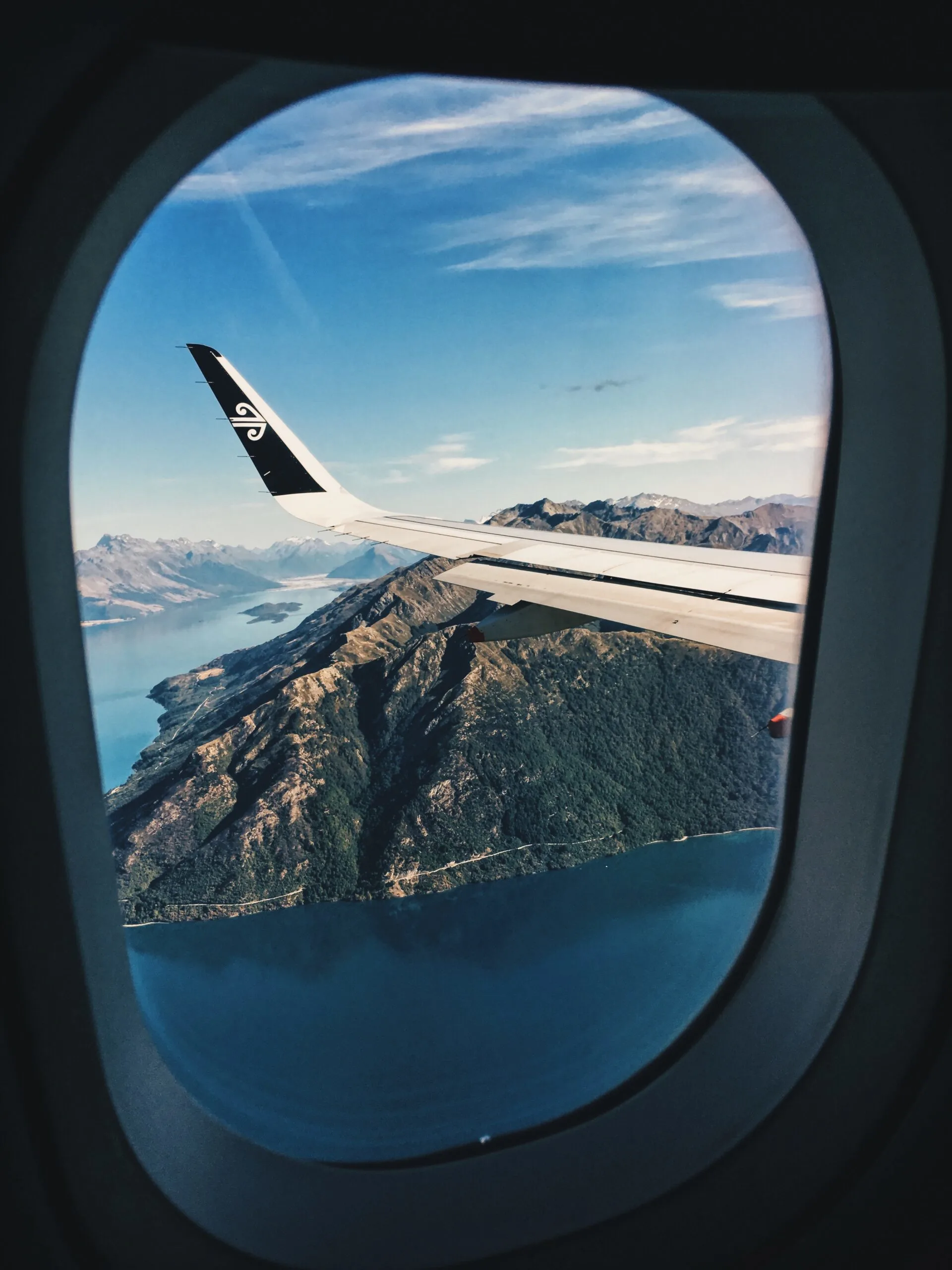 White Airplane Window showing mountains