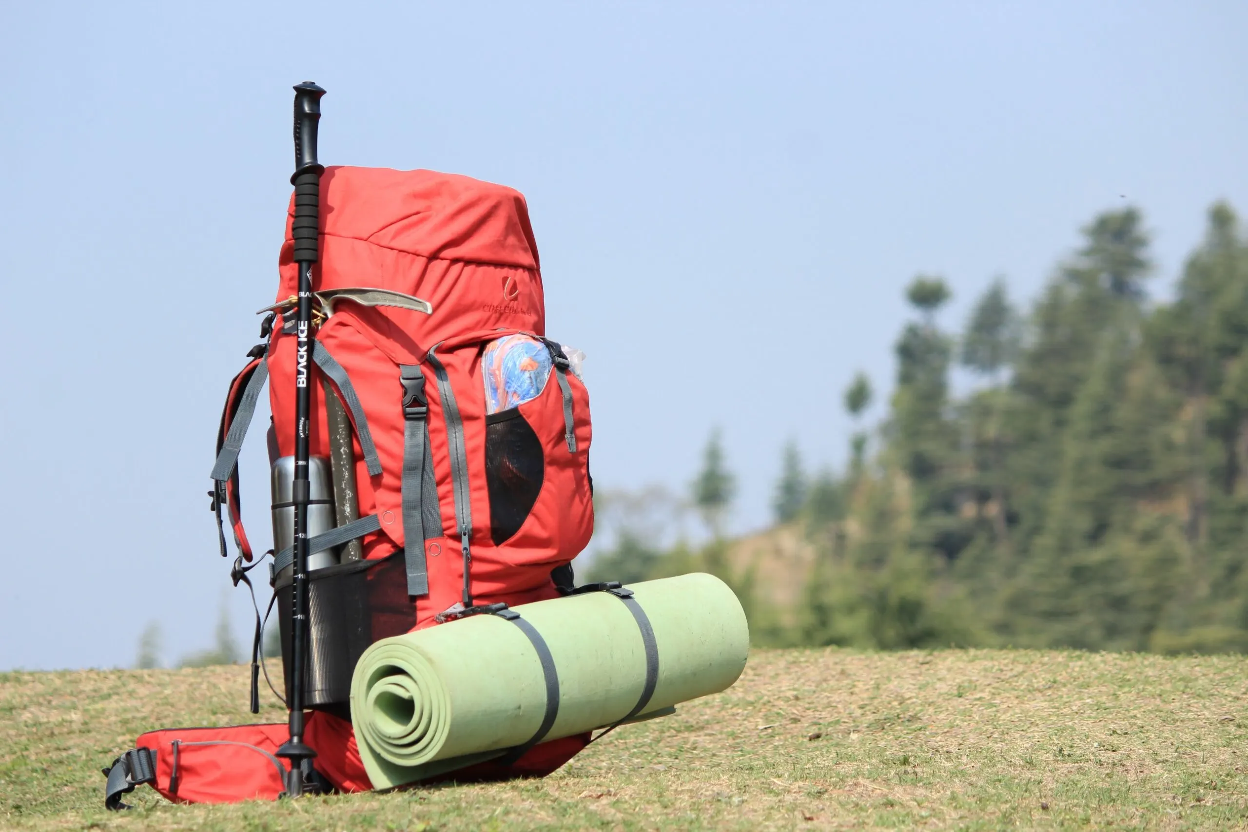 Red Hiking Backpack on Green Grass